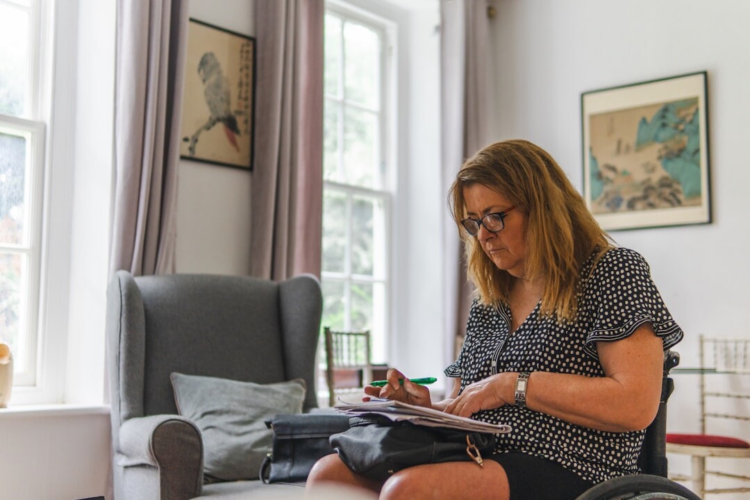 Senior woman reading a newspaper at home