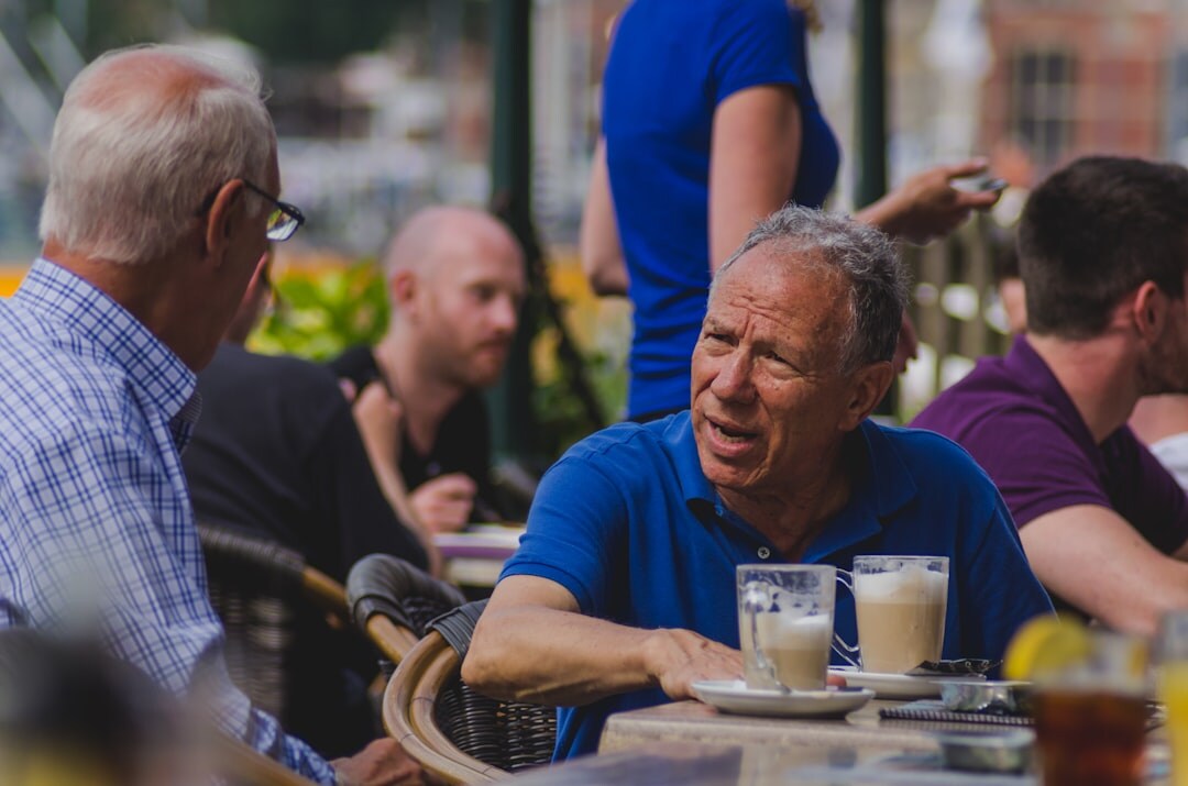 Seniors chatting and drinking coffee at a club meeting