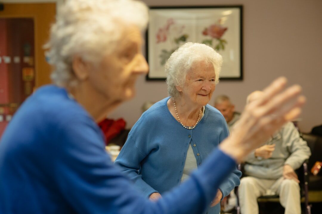 Seniors doing a gentle group exercise class